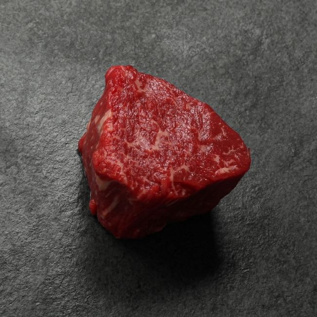 angled view of a raw American-Wagyu Hybrid 4 oz filet mignon