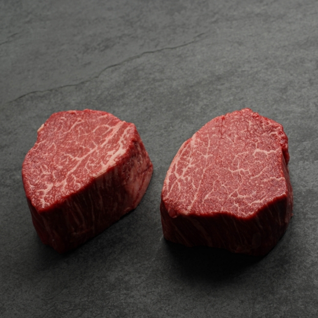 angled view of two heavily marbled australian wagyu filet mignon steaks